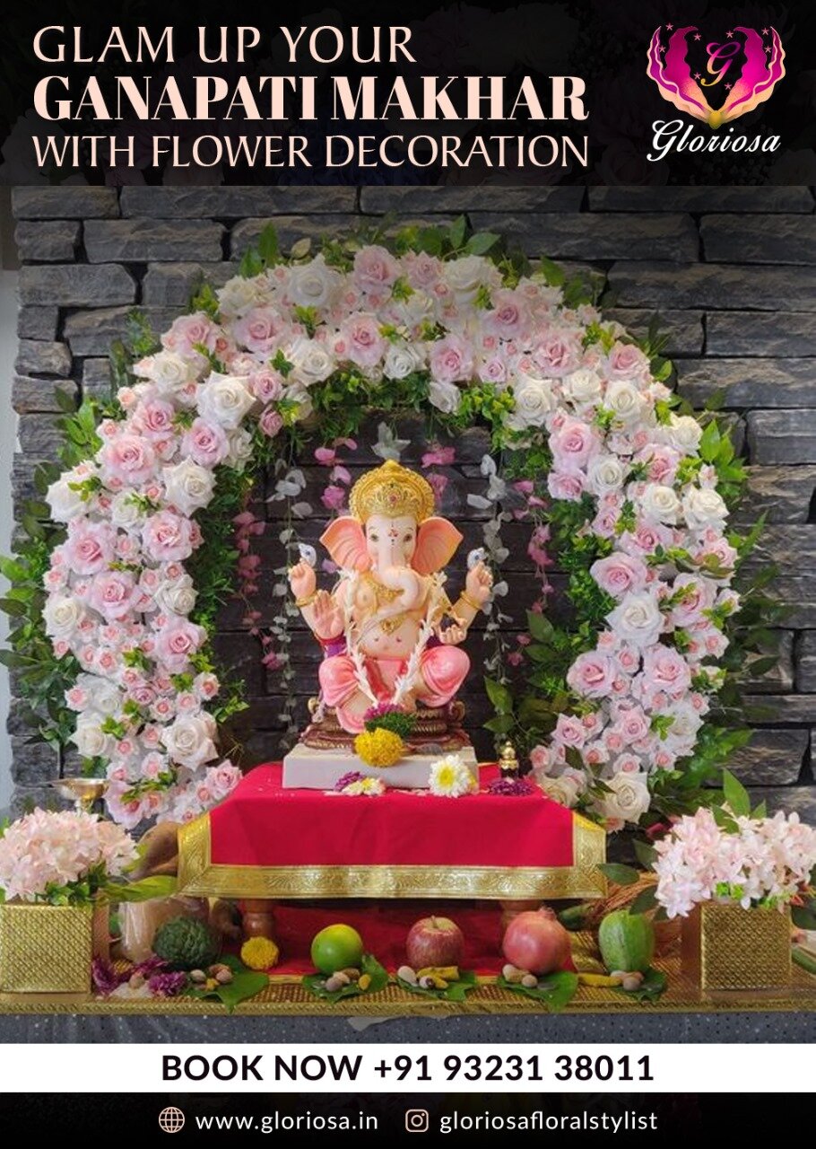 Ganpati makhar with pink roses arch on stone wall backdrop