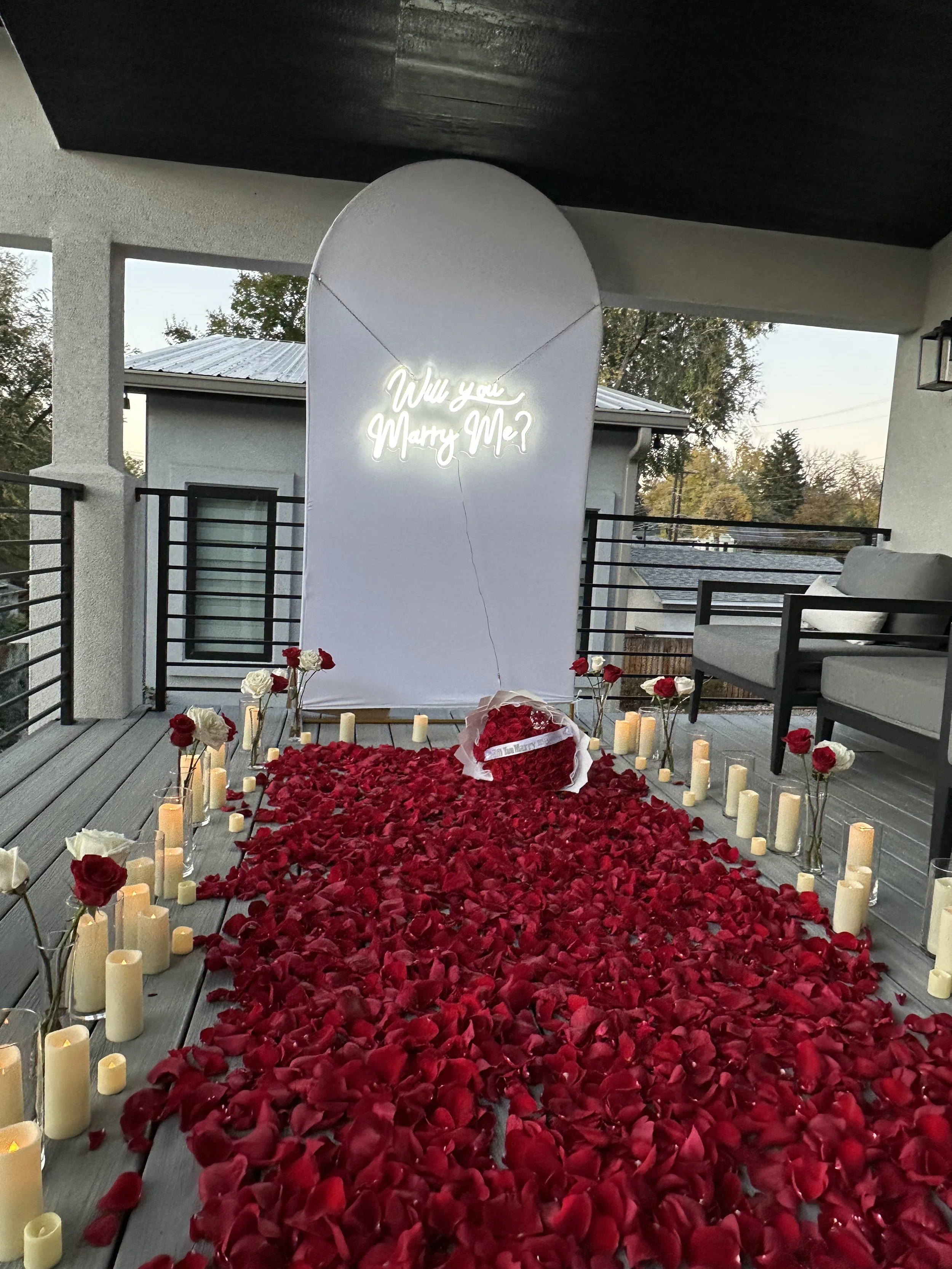 Romantic proposal setup with flowers and candles