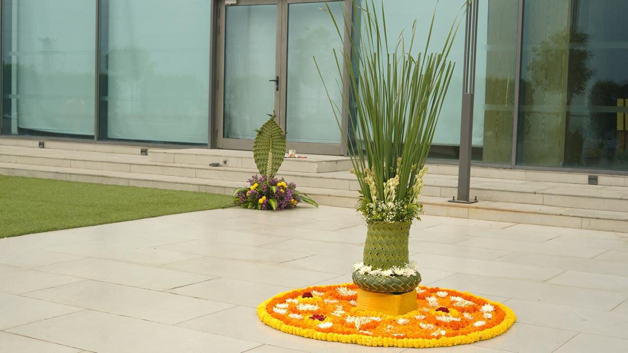 Traditional rangoli with palm vase outdoor setup