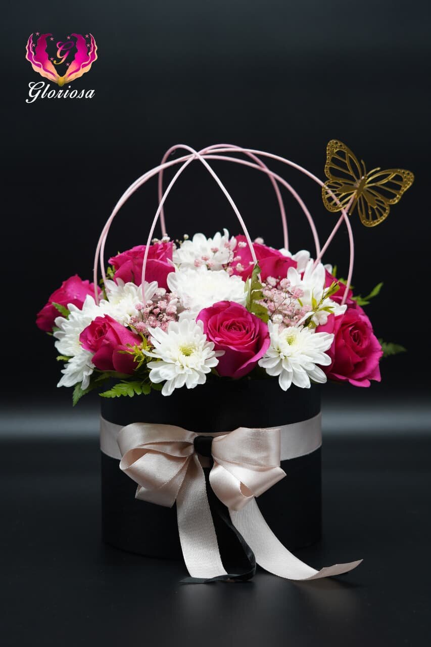 Roses and chrysanthemums in black cage box with butterfly