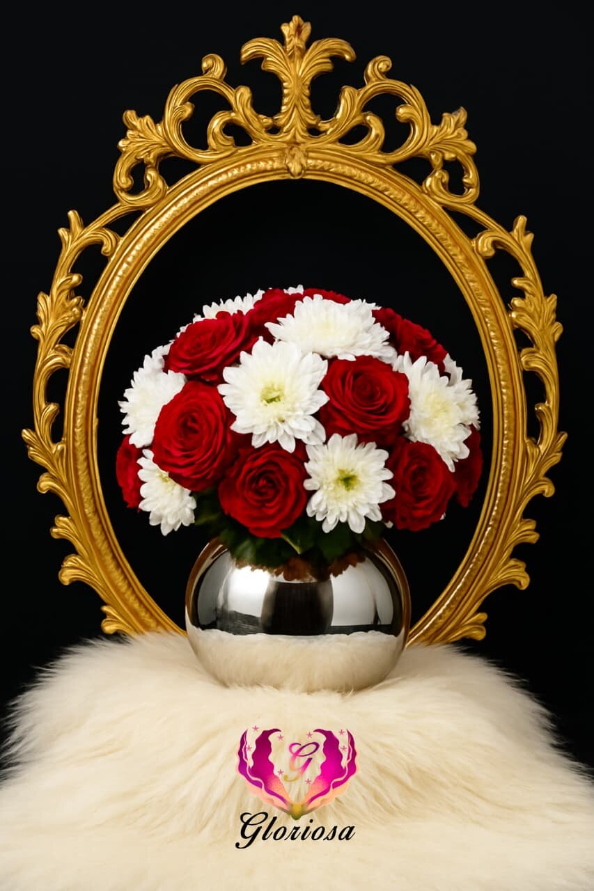 Red roses and chrysanthemums with ornate gold mirror frame