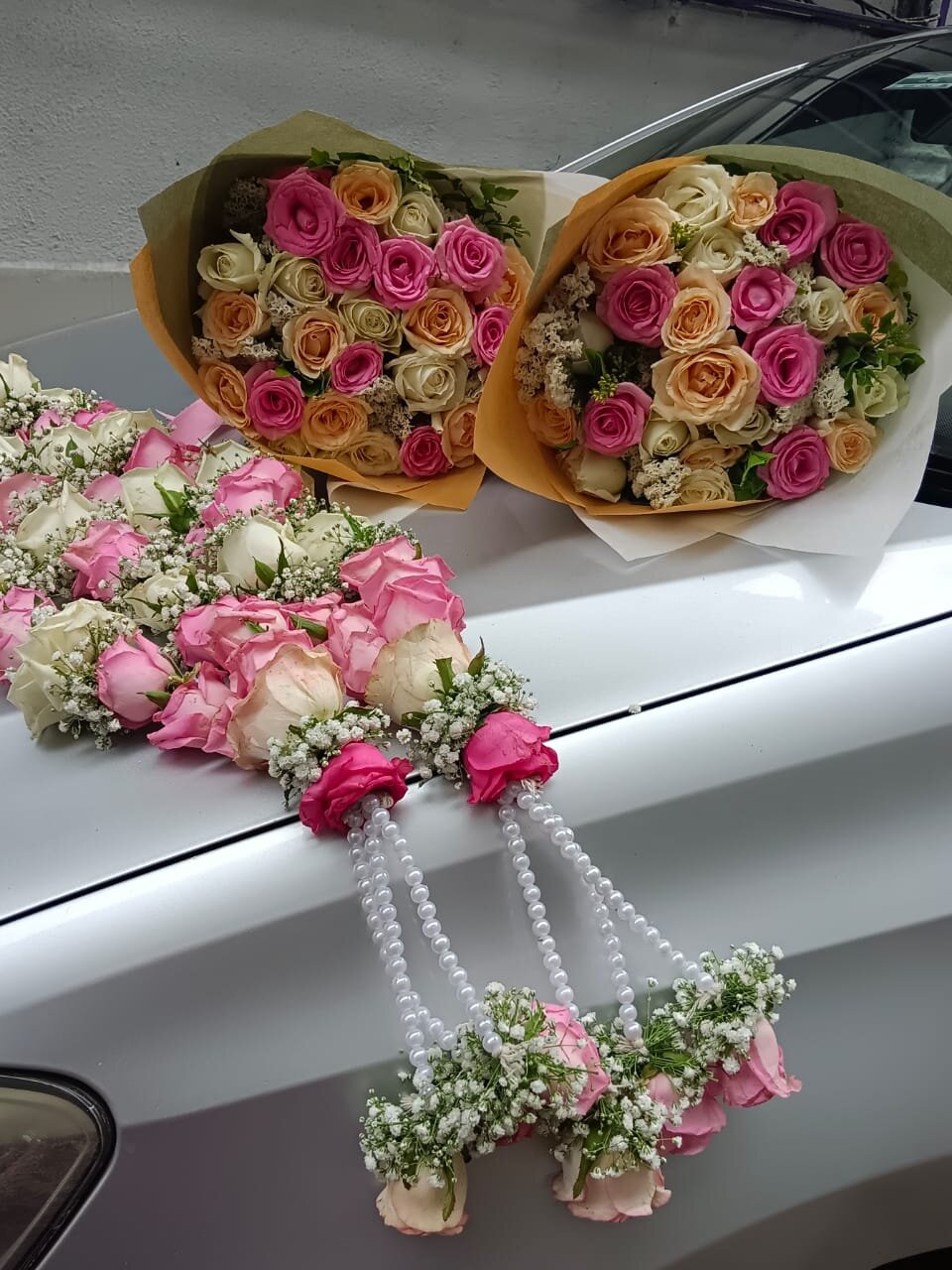 White roses and orchids in elegant golden vase arrangement